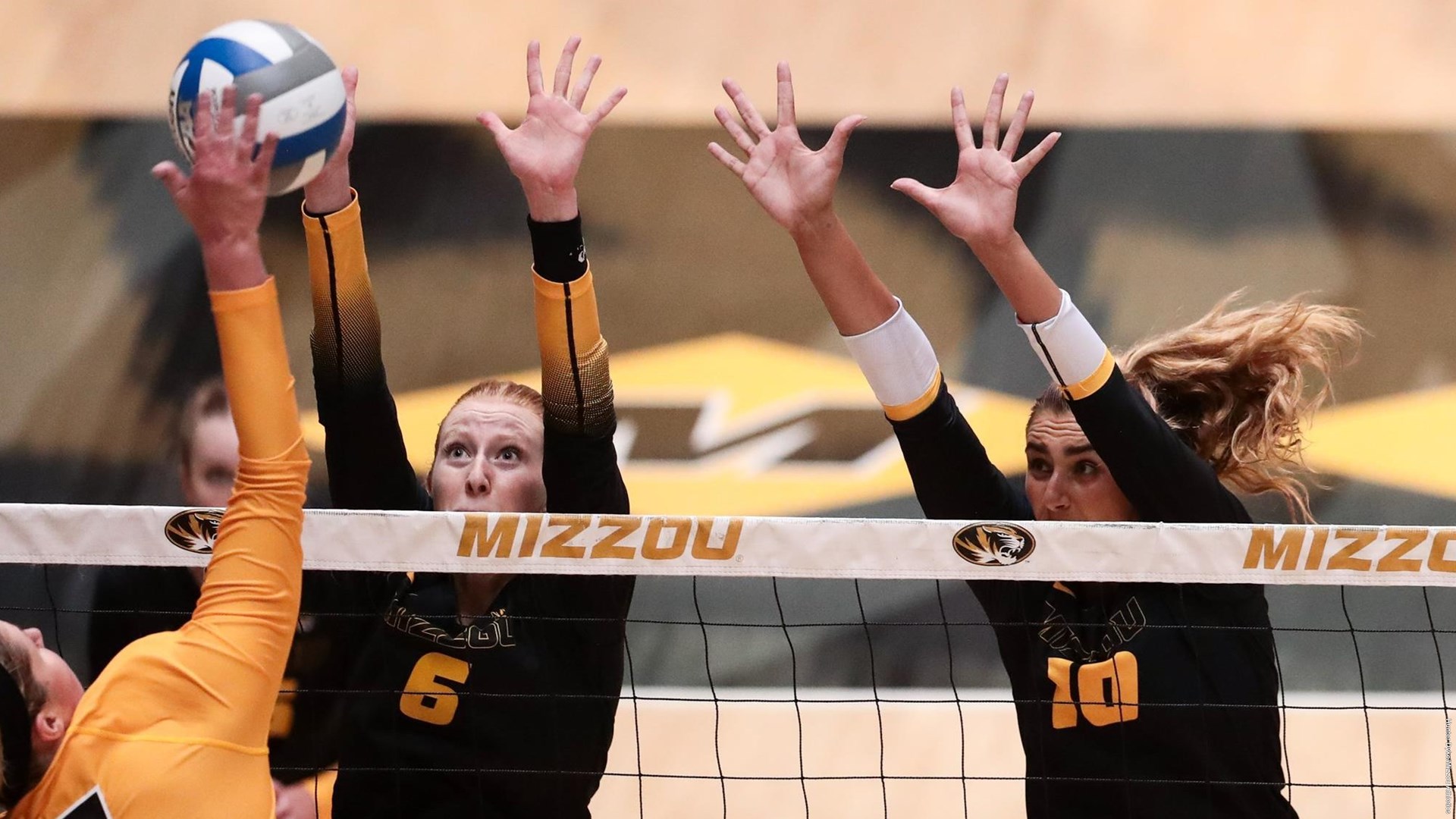 Kaylee Cox and Anna Dixon go up for a block at the Black and Gold match