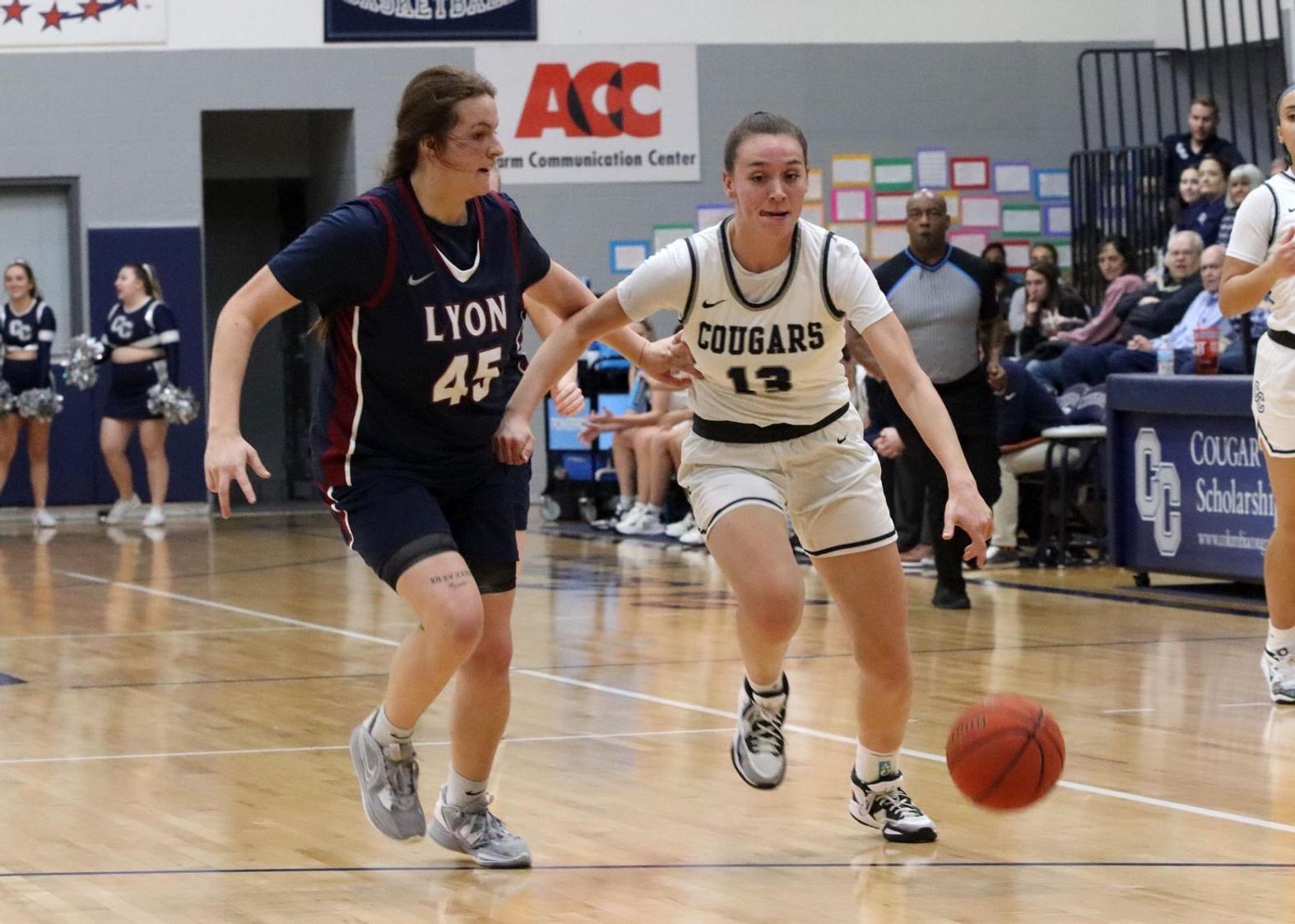 Lexi Miller drives to the bucket against Lyon